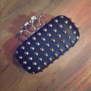Black skull studded knuckle clutch.